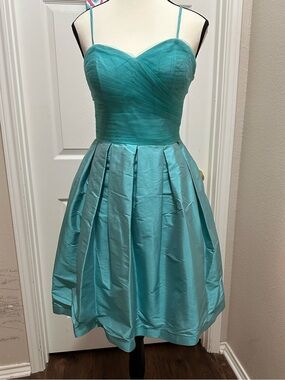 Light green strapless party dress with pleated skirt